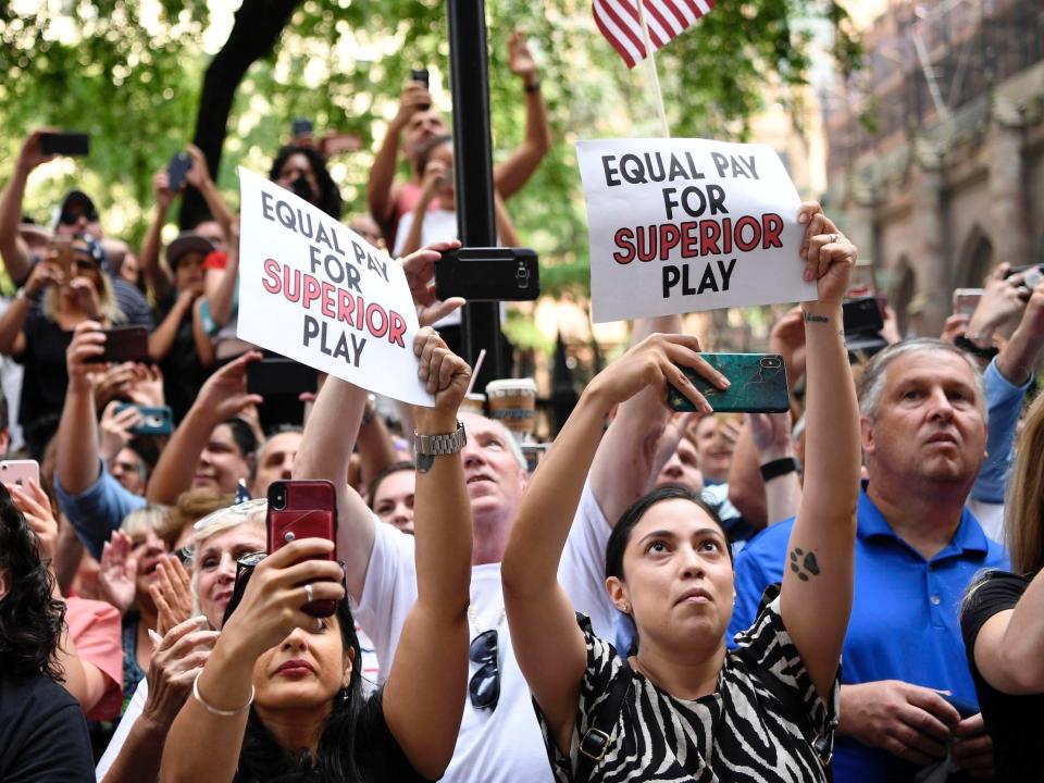 Fans lobby for equal pay during the USWNT's 2019 World Cup victory parade in New York City.