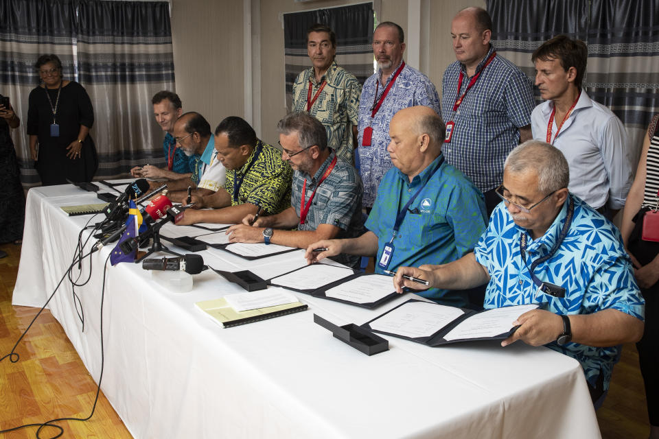 Members of Pacific fishing and community groups sign documents during the Pacific Islands Forum in in Nauru, Wednesday, Sept. 5, 2018. The groups signed an agreement with the European Union to improve sustainable fishing and ocean governance in the region. (Jason Oxenham/Pool Photo via AP)