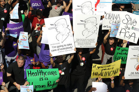 People march in a "Save Obamacare" rally on the seventh anniversary of Obamacare's signing, in Los Angeles, California, U.S. March 23, 2017. REUTERS/Lucy Nicholson