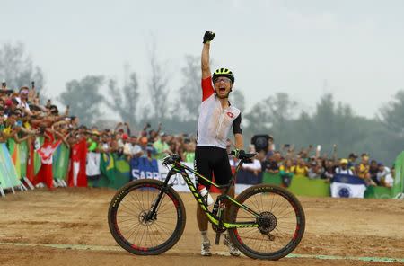 2016 Rio Olympics - Cycling mountain bike - Final - Men's Cross-country Race - Mountain Bike Centre - Rio de Janeiro, Brazil - 21/08/2016. Nino Schurter (SUI) of Switzerland celebrates winning the gold medal. REUTERS/Paul Hanna