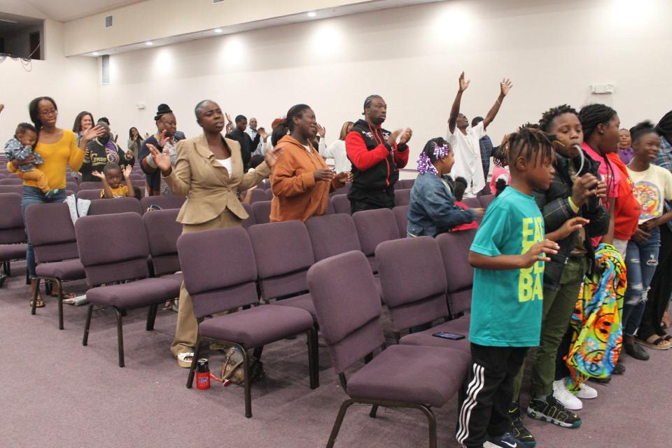 Parishioners praise the Lord during a service celebrating the 23rd anniversary of Superintendent Karl Anderson and Shepherdess Pearlie Shelton as pastors and co-founders of the northeast Gainesville Church.
(Credit: Photo by Voleer Thomas, Correspondent)