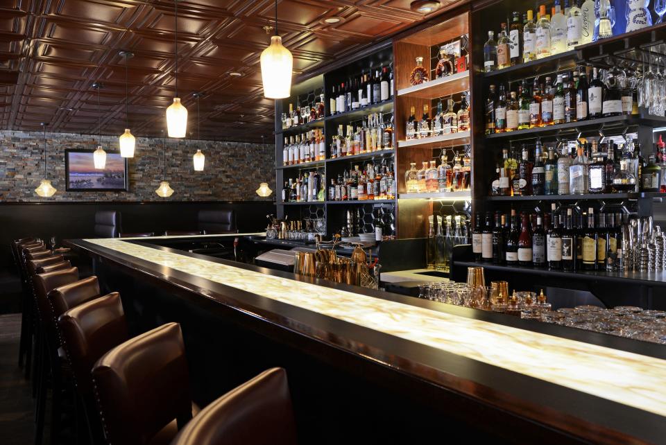 The bar at the new Lewis Steakhouse in Jupiter glows in more ways than one.