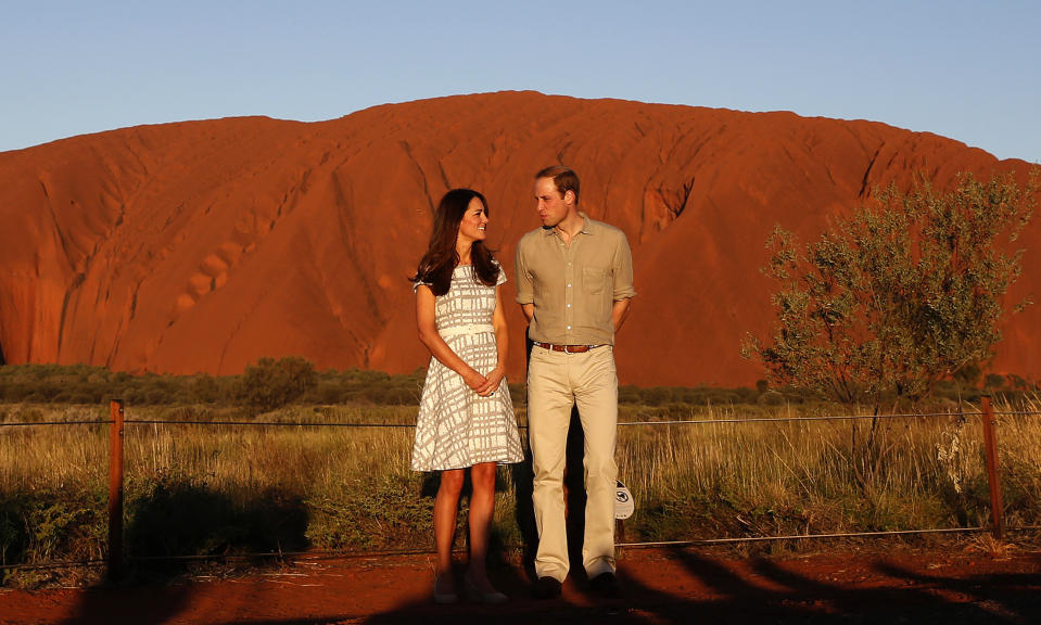 Britain's Prince William and his wife Catherine, Duchess of Cambridge, pose in front of Uluru, also known as Ayers Rock, April 22, 2014. Britain's Prince William, his wife Kate and their son Prince George are on a three-week tour of New Zealand and Australia. REUTERS/Phil Noble (AUSTRALIA - Tags: ROYALS ENTERTAINMENT TPX IMAGES OF THE DAY)