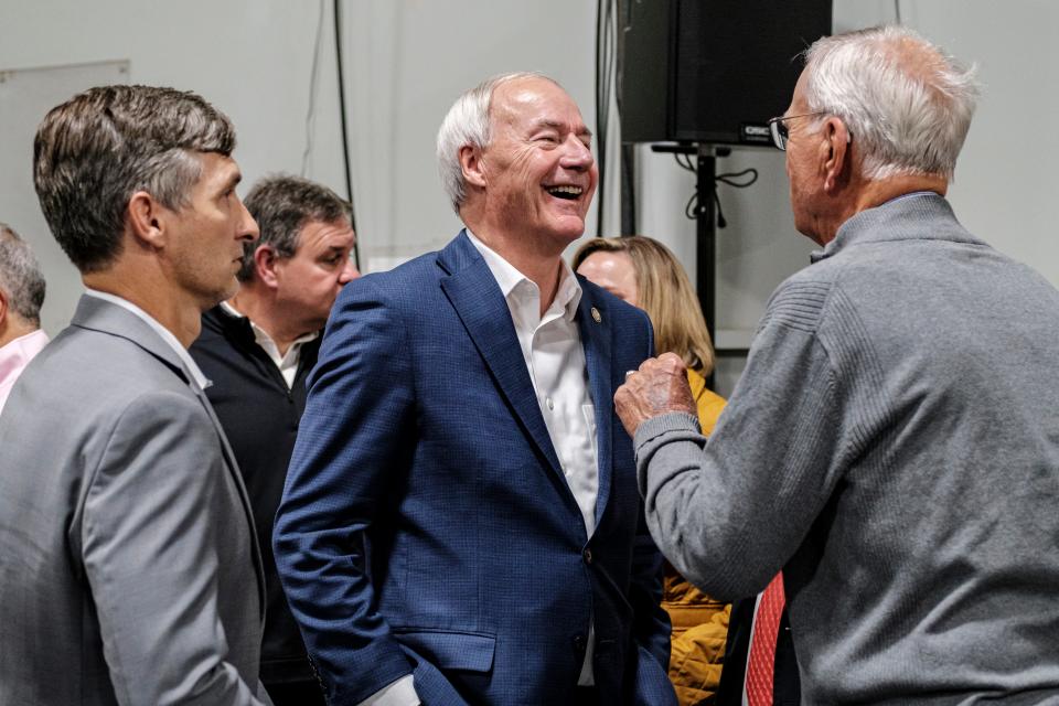 Former Arkansas Gov. Asa Hutchinson, center, speaks with attendees during U.S. Rep. Mariannette Miller-Meeks', R-Iowa, Triple MMM Tailgate event in Iowa City, Iowa, on Friday, Oct. 20, 2023. The event featured remarks from several candidates for the Republican Party's nomination for president.