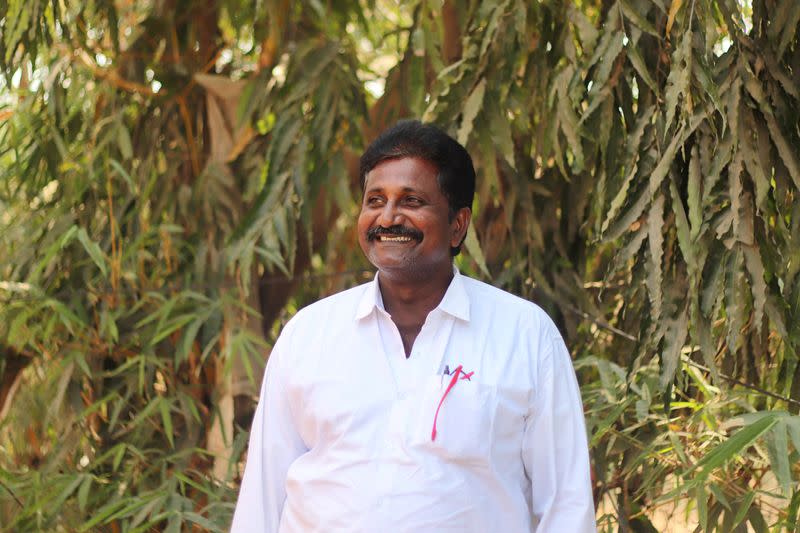 Lokeswara Reddy reacts as he poses for a photograph at a processing unit in Krishna district