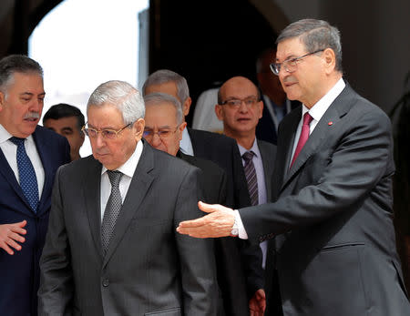 Algerian Speaker of the National Assembly Abdulkader bin Saleh, left, who will represent his country on the Arab Summit, is welcomed by the Tunisian Presidential Advisor for political affairs, Habib Essid, right, upon his arrival at Tunis-Carthage International Airport to attend the Arab Summit, in Tunis, Tunisia March 30, 2019. Hussein Malla/Pool via REUTERS