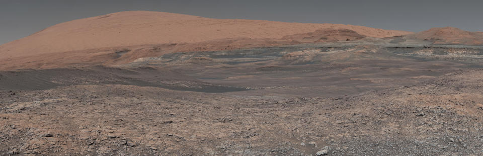 FILE - This image provided by NASA, assembled from a series of January 2018 photos made by the Mars Curiosity rover, shows an uphill view of Mount Sharp, which Curiosity had been climbing. In our solar system family, Mars is Earth’s next-of-kin, the next-door relative that has captivated humans for millennia. The attraction is sure to grow on Monday, Nov. 26 with the arrival of a NASA lander named InSight. (NASA/JPL-Caltech/MSSS via AP, File)