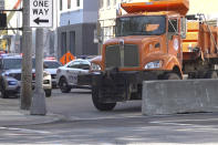 Officials add barriers block access to downtown, Tuesday, Sept. 22, 2020 in Louisville. Officials in Louisville were preparing Tuesday for more protests and possible unrest as the public nervously awaits the state attorney general’s announcement about whether he will charge officers in Breonna Taylor’s shooting death. Taylor's shooting has been followed by months of protests in the city. (AP Photo/ Dylan Lovan)