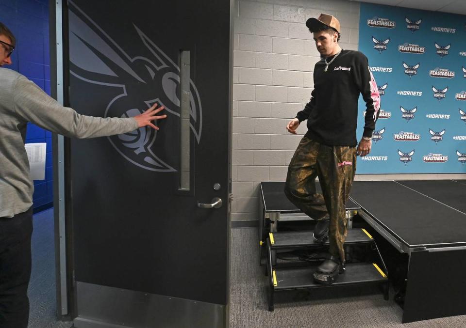 Charlotte Hornets guard LaMelo Ball, right, exits the interview room after answering questions from the local media on Monday, April 15, 2024.