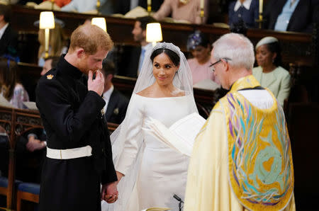 Prince Harry and Meghan Markle in St George's Chapel at Windsor Castle during their wedding service, conducted by the Archbishop of Canterbury Justin Welby in Windsor, Britain, May 19, 2018. Dominic Lipinski/Pool via REUTERS