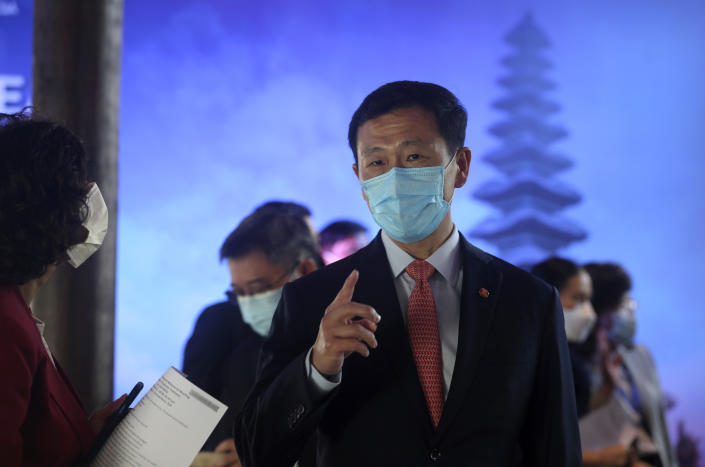 Singapore's Health Minister Ong Ye Kung talks with his staff during the 15th ASEAN Health Ministers meeting in Bali, Indonesia on Saturday, May 14, 2022. in Bali, Indonesia on Saturday, May 14, 2022. (AP Photo/Firdia Lisnawati)