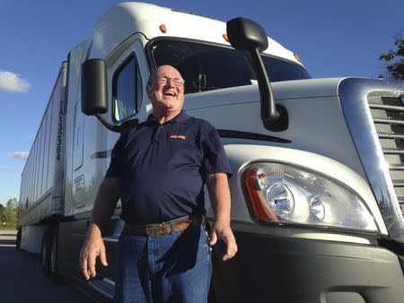 Bob Wyatt, who has driven more than 4 million miles over four decades for truck firm Schneider National, is pictured outside the company’s headquarters in Green Bay, Wisconsin, U.S. October 1, 2015. The trucking industry is short on drivers and a new regulation mandating truckers switch to electronic logs is expected to make the shortage far worse. REUTERS/Nick Carey