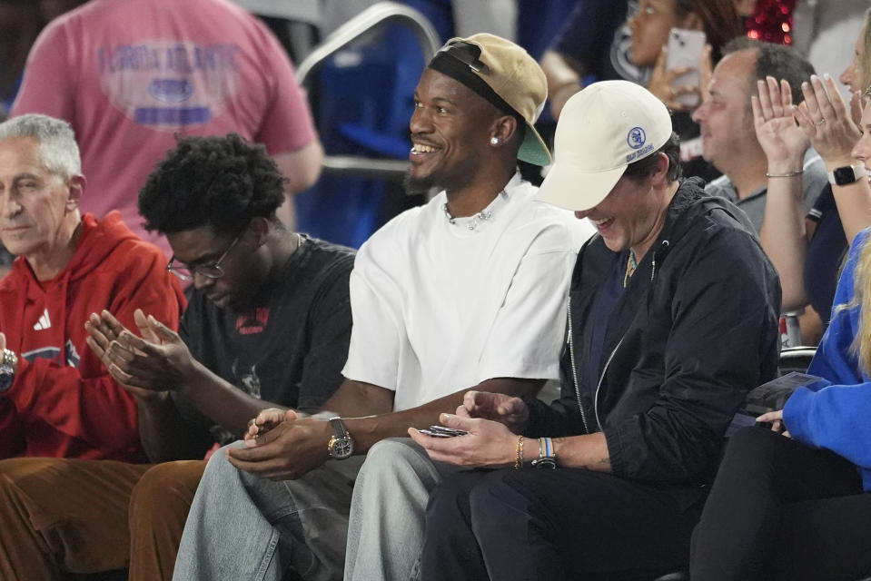 Miami Heat player Jimmy Butler watches the first half of an NCAA college basketball game between Florida Atlantic and the Wichita State, Thursday, Jan. 18, 2024, in Boca Raton, Fla. (AP Photo/Marta Lavandier)