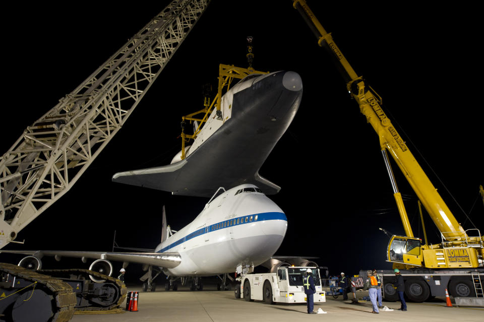 In this photo provided by NASA, the NASA 747 Shuttle Carrier Aircraft moves into place for mating underneath the space shuttle Enterprise for transport to New York at Washington Dulles International Airport, Friday, April 20, 2012, in Sterling, Va. Enterprise is expected to go on display at the Intrepid Sea Air and Space Museum in New York. (AP Photo/NASA, Bill Ingalls)