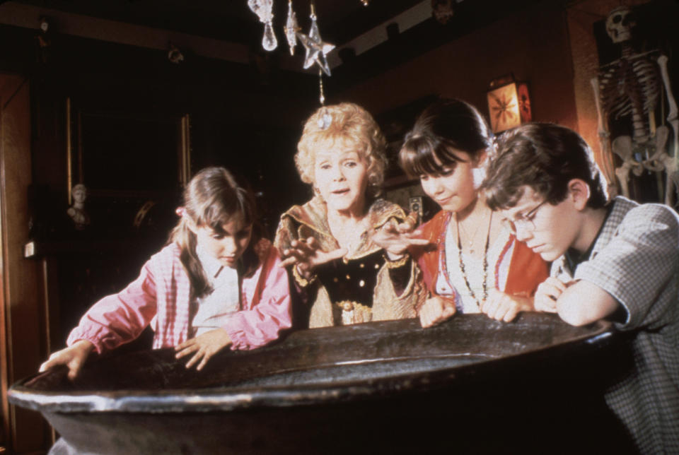 Emily Roeske, Debbie Reynolds, Kimberly J. Brown, Joey Zimmerman looking over a cauldron in Halloweentown