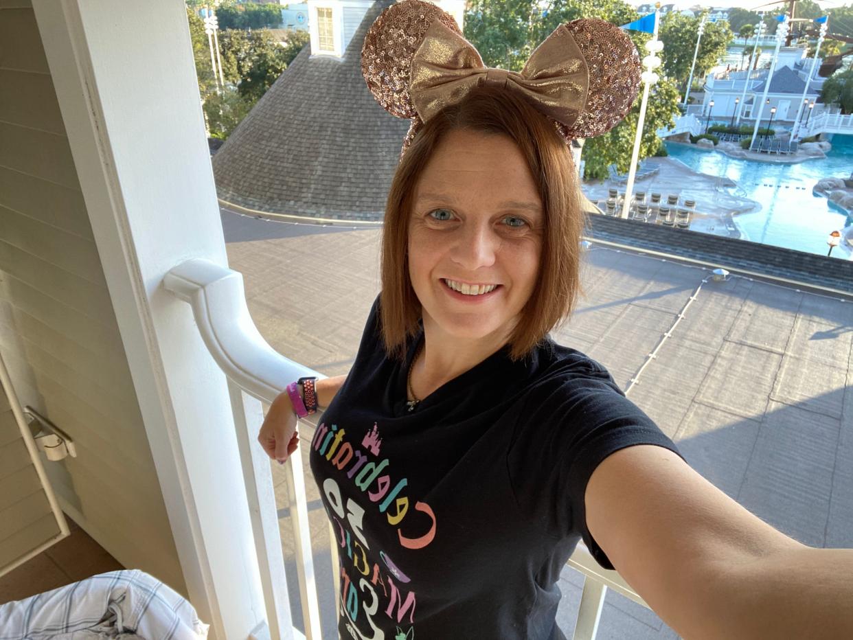 kari posing in minnie ears on the balcony of the yacht club resort