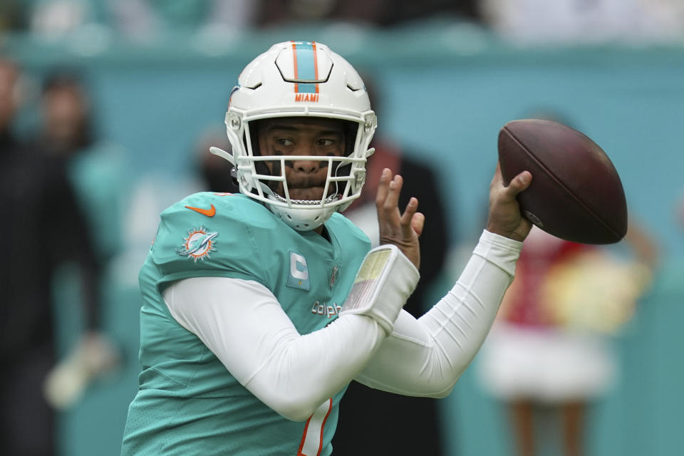 FILE - Miami Dolphins quarterback Tua Tagovailoa (1) looks to pass during the first half of an NFL football game against the Green Bay Packers, Sunday, Dec. 25, 2022, in Miami Gardens, Fla. Dolphins quarterback Tagovailoa sustained his second concussion of the season in last week’s loss to Green Bay, Miami coach Mike McDaniel confirmed Wednesday, Dec. 28. Tagovailoa has not been officially ruled out for Sunday's pivotal game at New England, though it's unknown when the Dolphins will see him on the field again. (AP Photo/Jim Rassol, File)