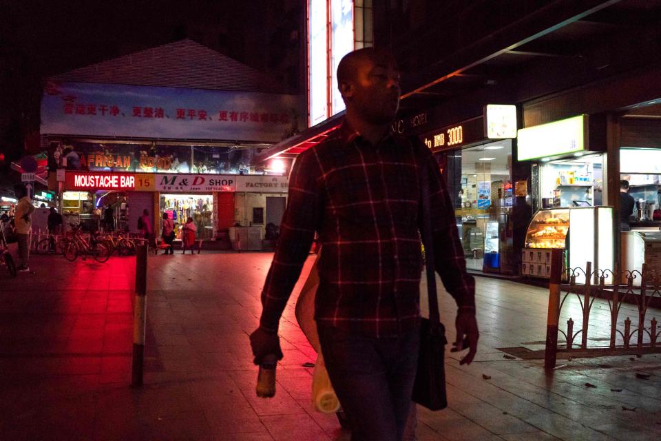 This file photo taken on March 2, 2018 shows people walking in the "Little Africa" district in Guangzhou, the capital of southern China's Guangdong province. - Africans in southern China's largest city say they have become targets of suspicion and subjected to forced evictions, arbitrary quarantines and mass coronavirus testing as the country steps up its fight against imported infections.