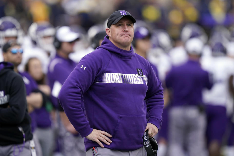 FILE - Northwestern head coach Pat Fitzgerald stands on the sideline during the first half of an NCAA college football game against Michigan, Oct. 23, 2021, in Ann Arbor, Mich. Former Northwestern University football coach Pat Fitzgerald is suing the school for $130 million, saying his alma mater wrongfully fired him in the wake of a hazing and abuse scandal that has engulfed the athletic department. The announcement by Chicago-based attorneys Dan K. Webb and Matthew R. Carter on Thursday, Oct. 5, 2023, comes nearly three months after Fitzgerald was suspended and then fired after 17 years. (AP Photo/Carlos Osorio, File)