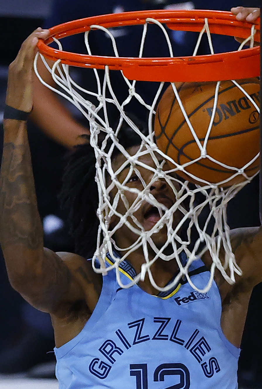 Memphis Grizzlies' Ja Morant dunks against the Portland Trail Blazers during the second half of an NBA basketball game Saturday, Aug. 15, 2020, in Lake Buena Vista, Fla. (Kevin C. Cox/Pool Photo via AP)