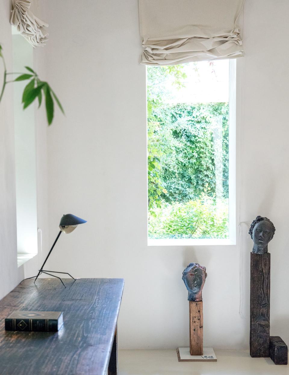A sun-drenched corner of the home. Sculptures by Vanessa Beecroft; Serge Mouille desk lamp.