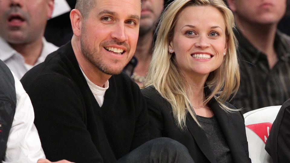 Jim Toth (L) and Reese Witherspoon attend a game between the Detroit Pistons and the Los Angeles Lakers at Staples Center on January 4, 2011 in Los Angeles, California