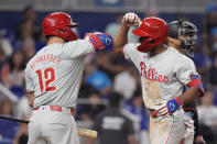 Philadelphia Phillies' Johan Rojas, right, celebrates with Kyle Schwarber (12) after Rojas hit a home run during the seventh inning of a baseball game against the Miami Marlins, Friday, May 10, 2024, in Miami. (AP Photo/Wilfredo Lee)