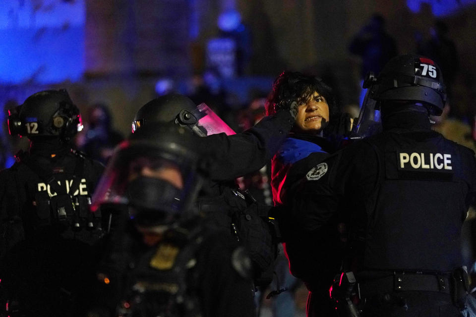 Portland police detain a man during protests, Saturday, Sept. 26, 2020, in Portland. The protests, which began over the killing of George Floyd, often result frequent clashes between protesters and law enforcement. (AP Photo/John Locher)