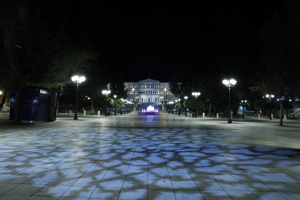 In this Thursday, April 2, 2020 photo, the main Athens' Syntagma square is seen empty during the lockdown. Deserted squares, padlocked parks, empty avenues where cars were once jammed bumper-to-bumper in heavy traffic. The Greek capital, like so many cities across the world, has seen its streets empty as part of a lockdown designed to stem the spread of the new coronavirus. (AP Photo/Thanassis Stavrakis)