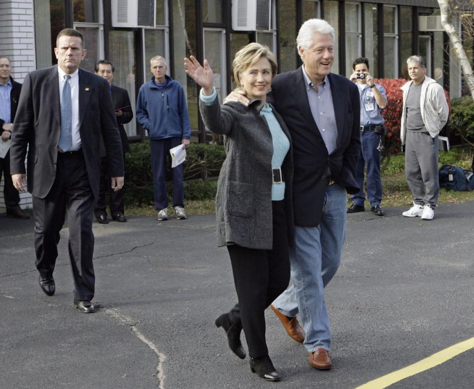 The Clintons wave to onlookers after voting in Chappaqua, N.Y.