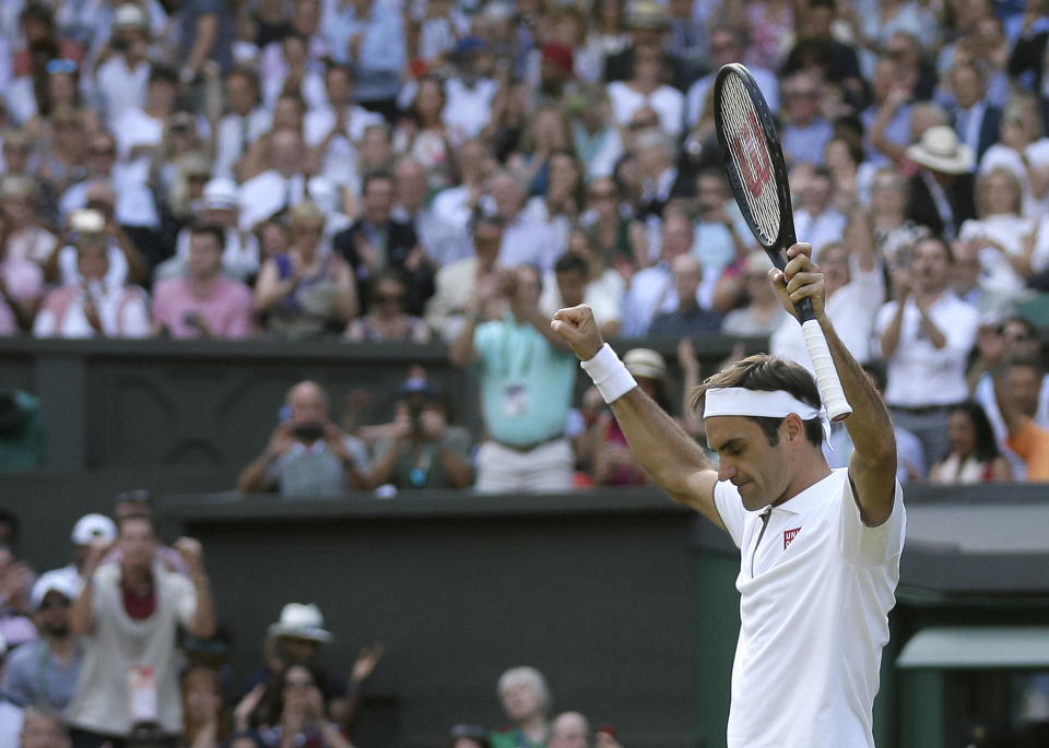 Switzerland's Roger Federer celebrates defeating Japan's Kei Nishikori during a men's quarterfinal match on day nine of the Wimbledon Tennis Championships in London, Wednesday, July 10, 2019. (AP Photo/Tim Ireland)