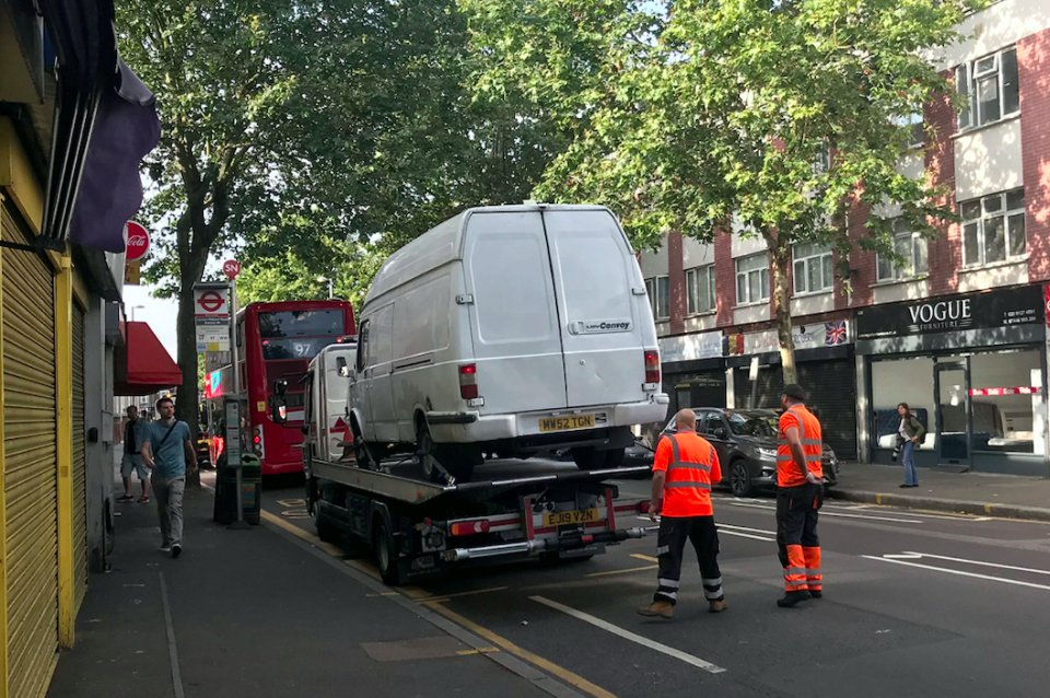 A van, believed to have been driven by the attacker, is loaded at the scene in Leyton this morning (PA)