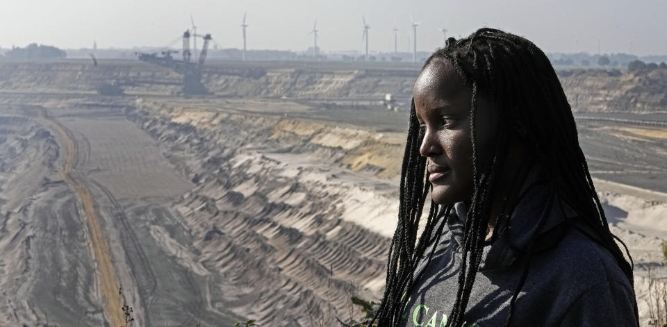 FILE - In this Saturday, Oct. 9, 2021 file photo, climate activist Vanessa Nakate from Uganda visits to the Garzweiler open-cast coal mine in Luetzerath, western Germany. “Everything is at stake if the leaders do not take climate action,” Nakate says. “We cannot eat coal. We cannot drink oil, and we cannot breathe so-called natural gas.” (AP Photo/Martin Meissner)