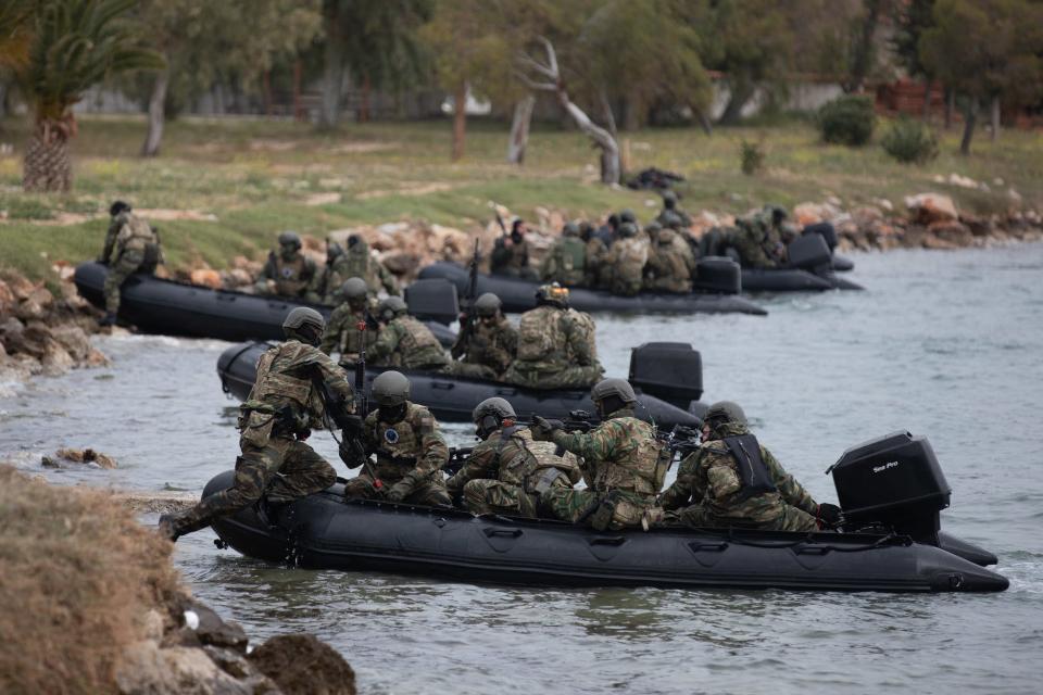 Special operations force members load into rafts in Greece