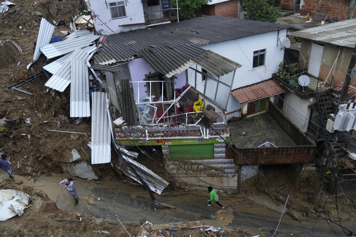 Damaged residences are seen after a landslide in Petropolis, Brazil, Wednesday, Feb. 16, 2022. Extremely heavy rains set off mudslides and floods in a mountainous region of Rio de Janeiro state, killing multiple people, authorities reported. (AP Photo/Silvia Izquierdo)