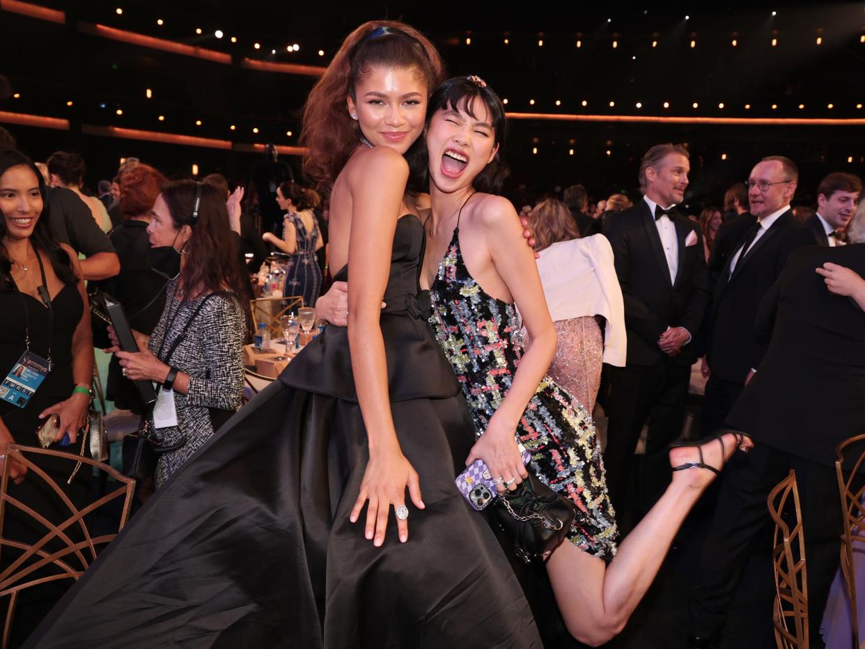zendaya and jung ho-yeon embracing at the emmy awards, hodling each other and grinning