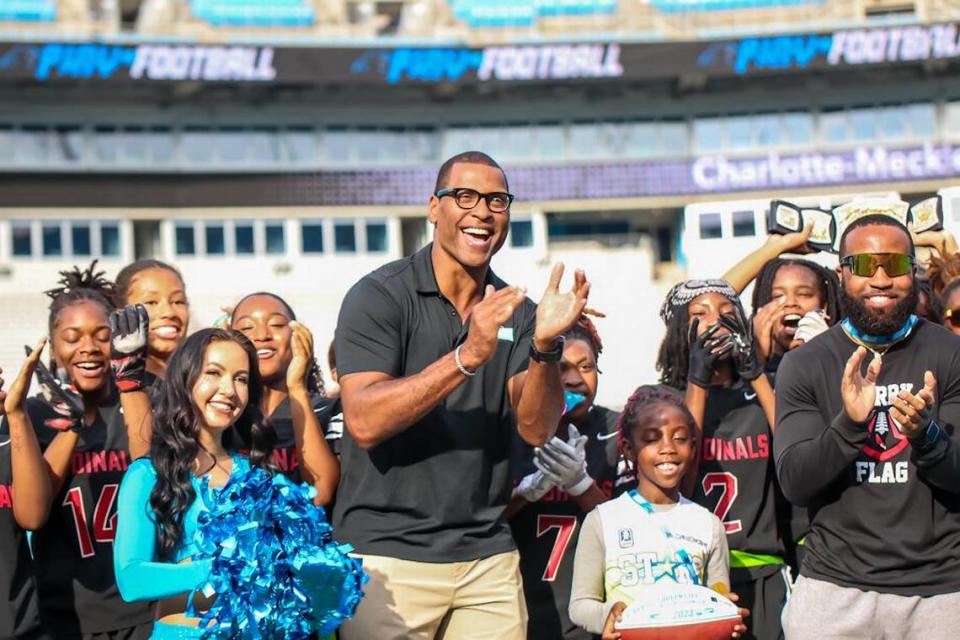 NFL Legend Mike Rucker celebrates with flag football teams at Bank of America Stadium in May 2023 to punctuate the second season of the Charlotte-Mecklenburg Schools girls’ flag football championship. Kelly Hood