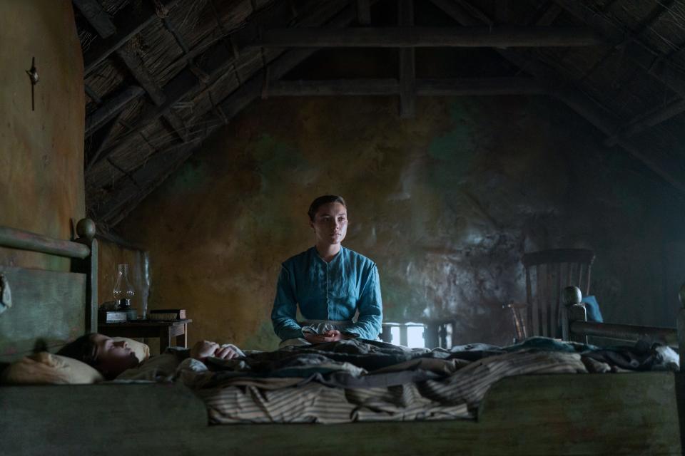 Florence Pugh (center) is an English nurse sent to Ireland to observe an 11-year-old girl (Kíla Lord Cassidy) said to have survived for months without any food in "The Wonder."