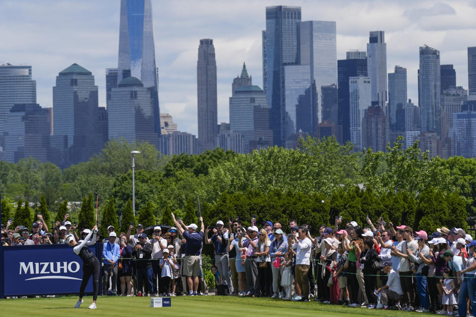 With the New York City skyline behind her, Nelly Korda, bottom left, hits off the first tee during the final round of the Mizuho Americas Open golf tournament, Sunday, May 19, 2024, in Jersey City, N.J. (AP Photo/Seth Wenig)