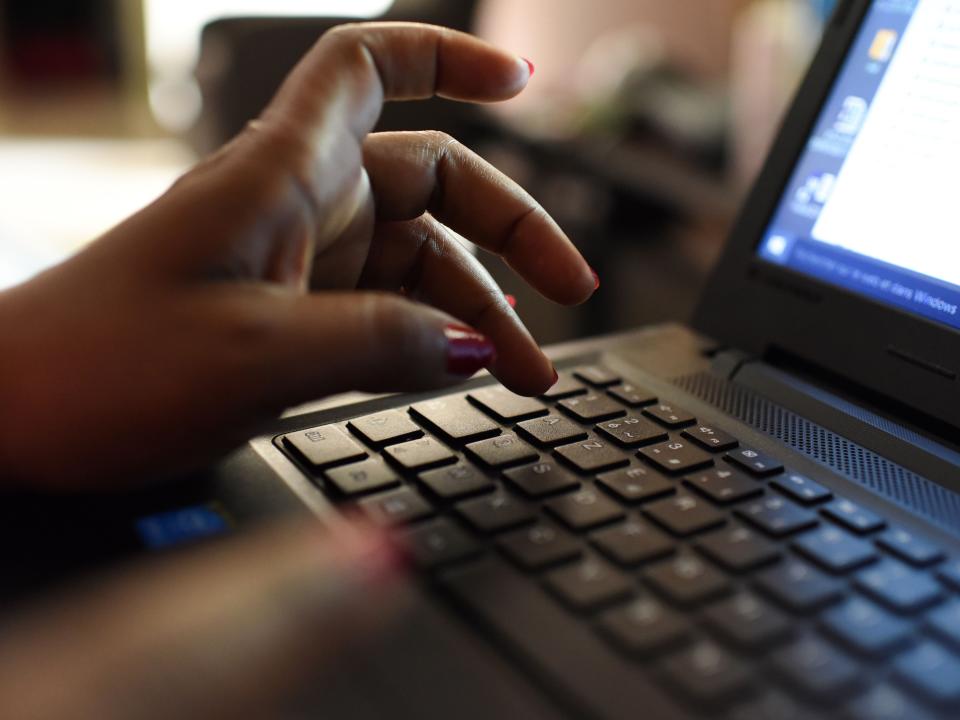 A woman uses a laptop.