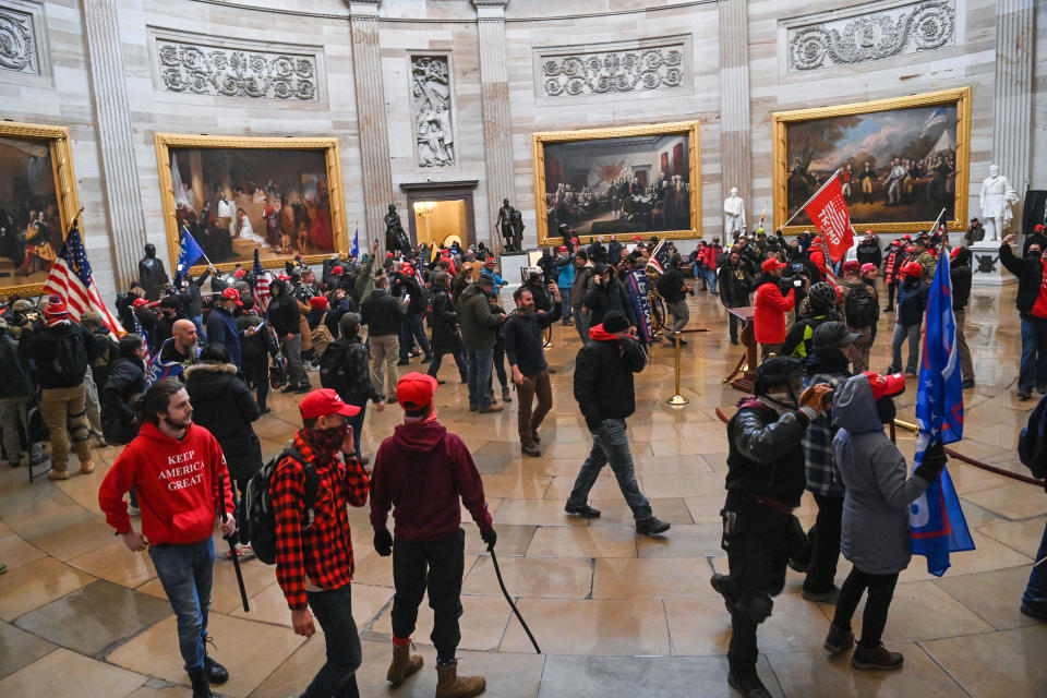 Trump supporters roam under the Capitol Rotunda.