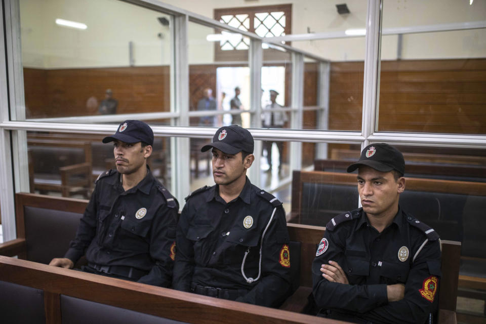 Security forces sit inside a court room before the start of a final trial session for suspects charged in connection with killing of two Scandinavian tourists in Morocco's Atlas Mountains, in Sale, near Rabat, Morocco, Thursday, July 18, 2019. The three main defendants in the brutal slaying of two female Scandinavian hikers have asked for forgiveness from Allah ahead of a verdict. (AP Photo/Mosa'ab Elshamy)