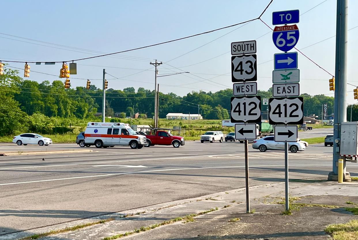 Early morning drivers travel through the intersection at Nashville Highway and Bear Creek Pike, what is considered the busiest intersection in the city.