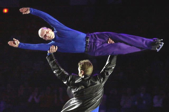 <p>Robert F. Bukaty/AP Photo</p> Scott Hamilton is held aloft by fellow skater Denis Petrov during a performance in the final event of Hamilton's touring career during a Stars on Ice show at the Cumberland County Civic Center, Saturday, April 7, 2001.