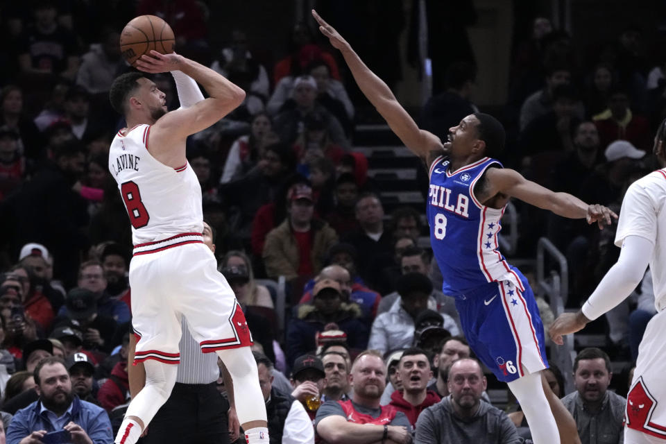 Chicago Bulls' Zach LaVine shoots as Philadelphia 76ers' De'Anthony Melton defends during the first half of an NBA basketball game Wednesday, March 22, 2023, in Chicago. (AP Photo/Charles Rex Arbogast)