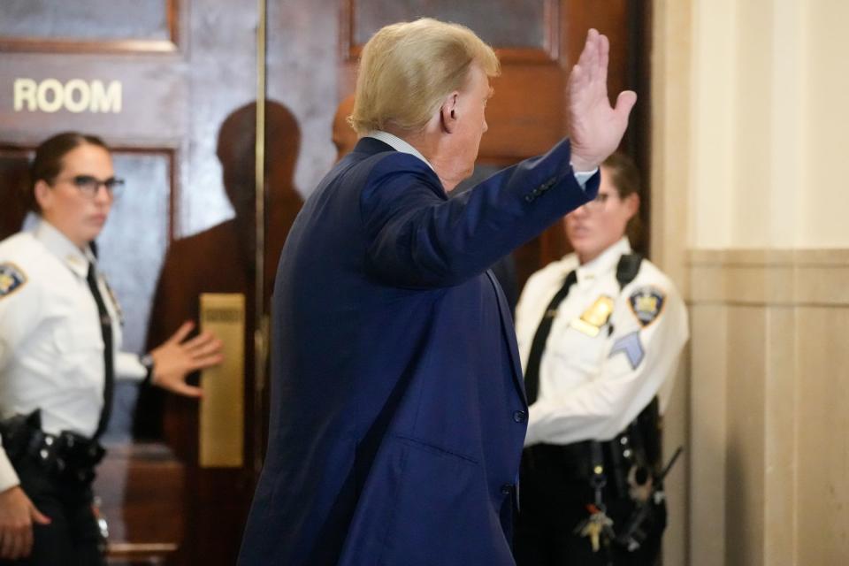 <p>AP Photo/Seth Wenig</p> Former President Donald Trump motions as he returns to the courtroom.