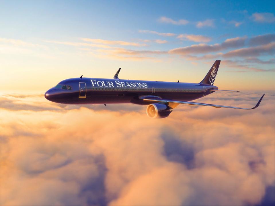 A rendered image of the Four Seasons Airbus A321LR in purple livery flying through a sunset.