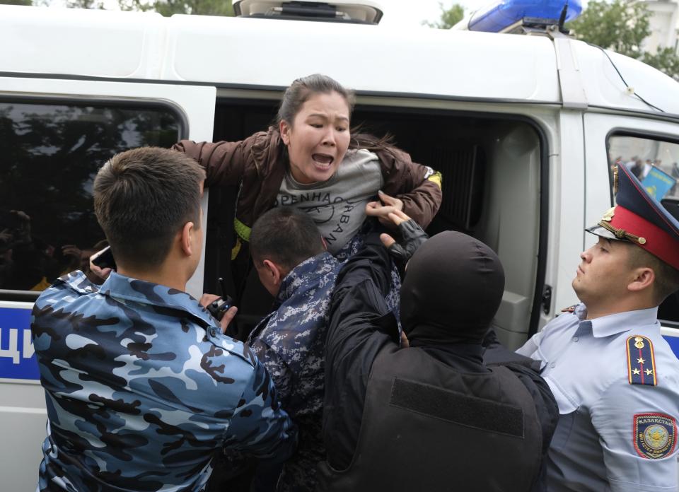 Kazakh police detain a demonstrator in Almaty, Kazakhstan, Wednesday, June 12, 2019, during protests against presidential elections. Protests have continued in the capital, Nur-Sultan, and in Almaty, Kazakhstan's principal city. Police detained 35 people Wednesday in Almaty as they gathered with plans to hold protests, the Interfax news agency reported. (AP Photo/Vladimir Tretyakov)