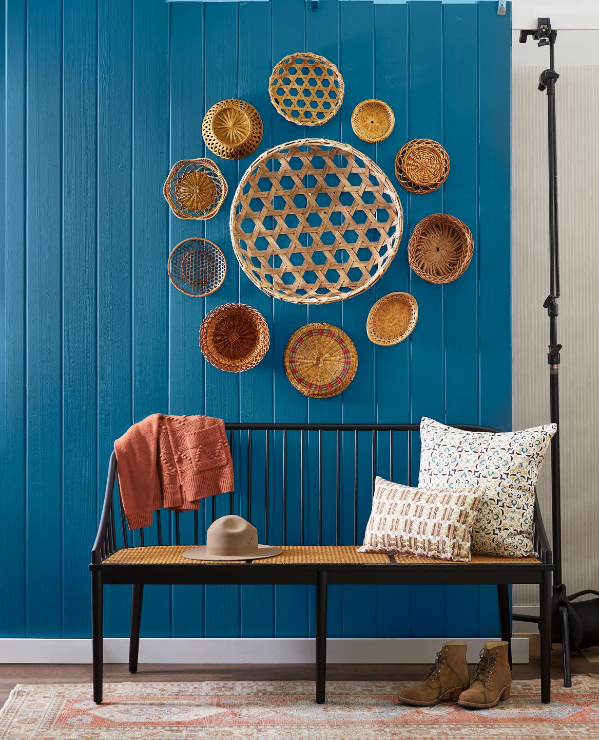 bench with gathering baskets on the wall above