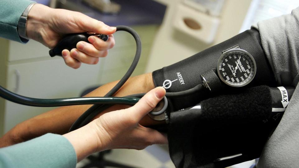 PHOTO: A doctor reads a blood pressure gauge during an examination at the Codman Square Health Center in Dorchester, Massachusetts.  (Joe Raedle/Getty Images)